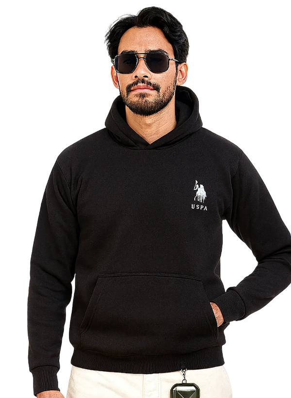 Man wearing a black hoodie with a logo, sunglasses, and white pants on a white background